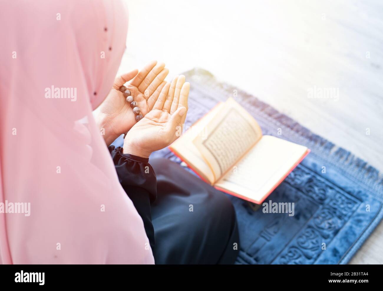 side of asian young beautiful muslim woman pray with beads and read