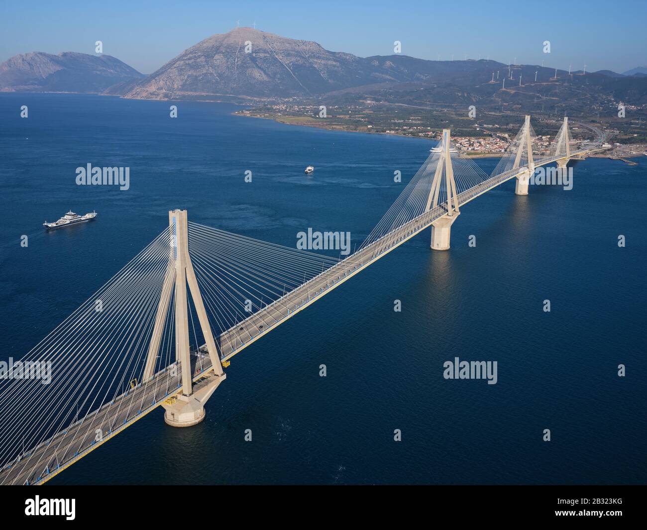 AERIAL VIEW. Large cable-stayed suspension bridge crossing the narrowest part of the Gulf of Corinth. Between the cities of Rio and Antirrio, Greece. Stock Photo