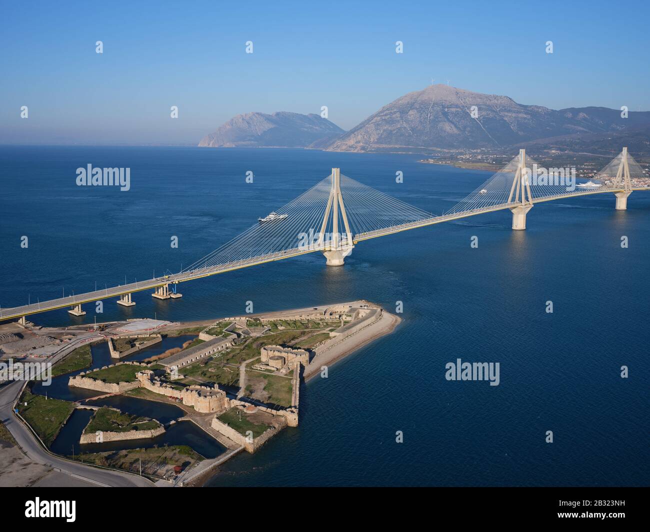 AERIAL VIEW. Large cable-stayed suspension bridge crossing the narrowest part of the Gulf of Corinth. Between the cities of Rio and Antirrio, Greece. Stock Photo