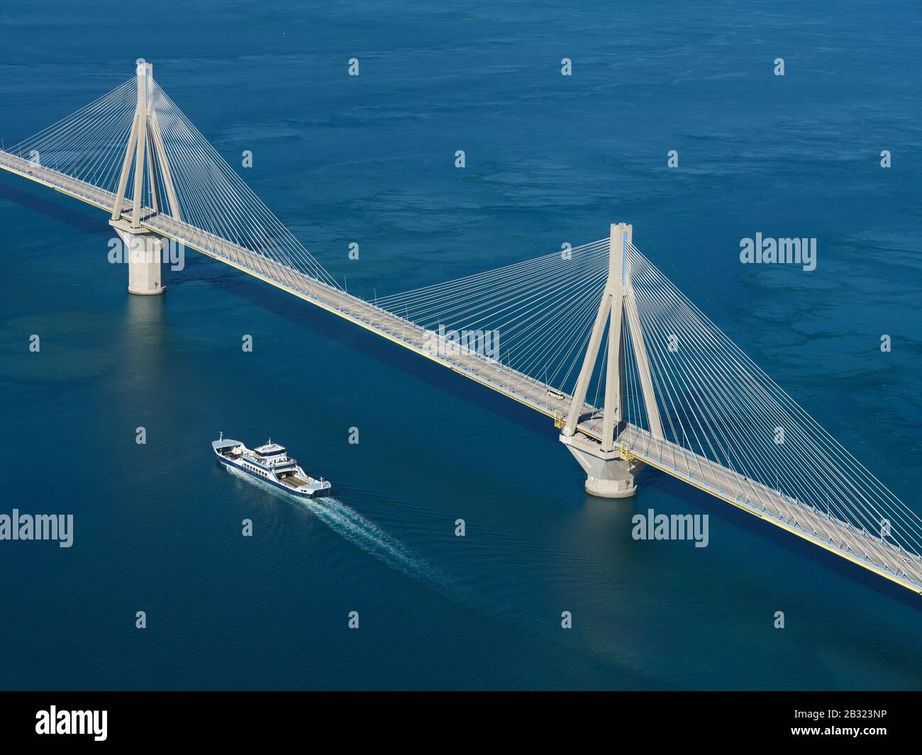 AERIAL VIEW. Large cable-stayed suspension bridge crossing the narrowest part of the Gulf of Corinth. Between the cities of Rio and Antirrio, Greece. Stock Photo