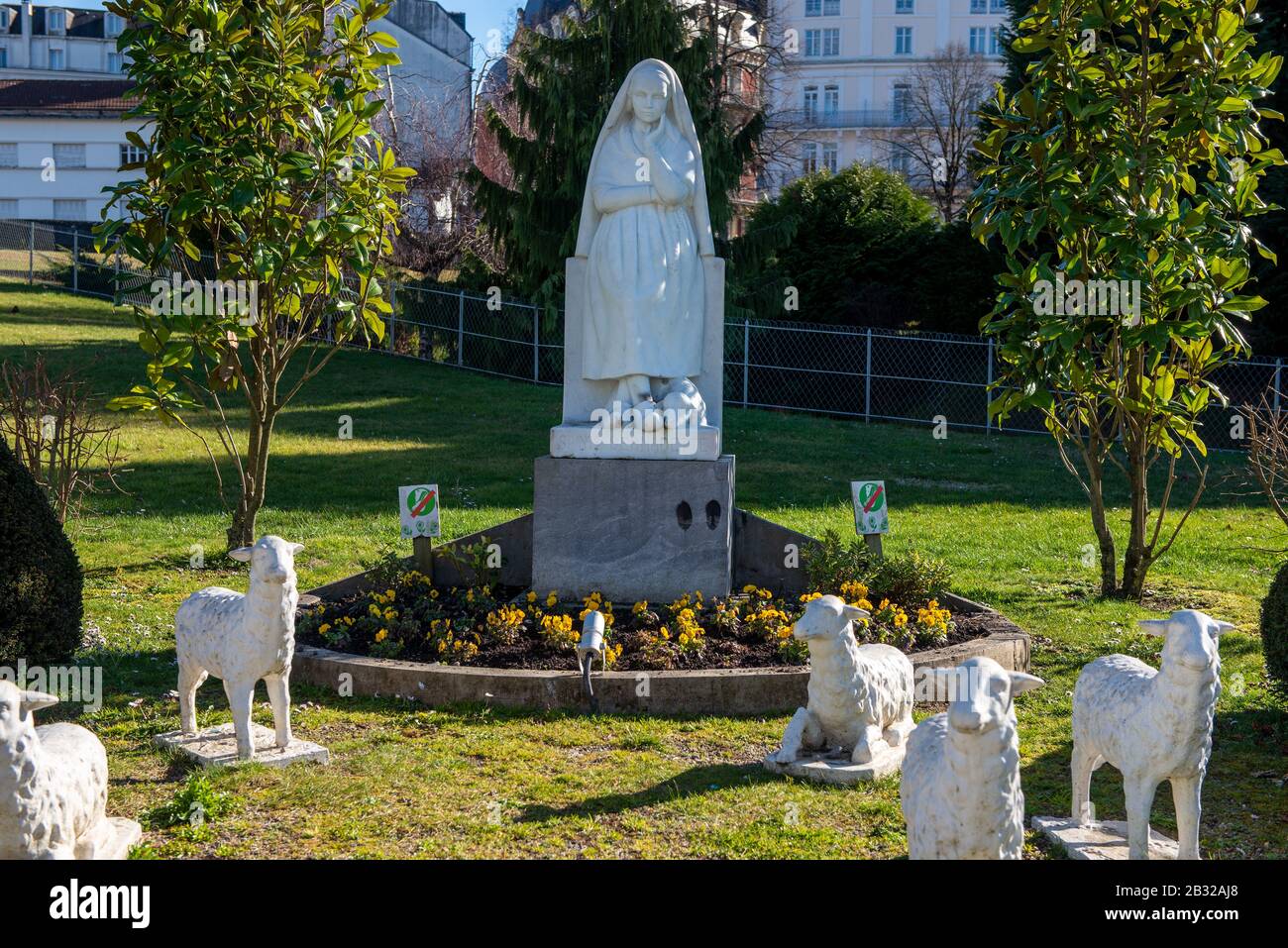 the Statue of Bernadette of Lourdes with flowers Stock Photo - Alamy