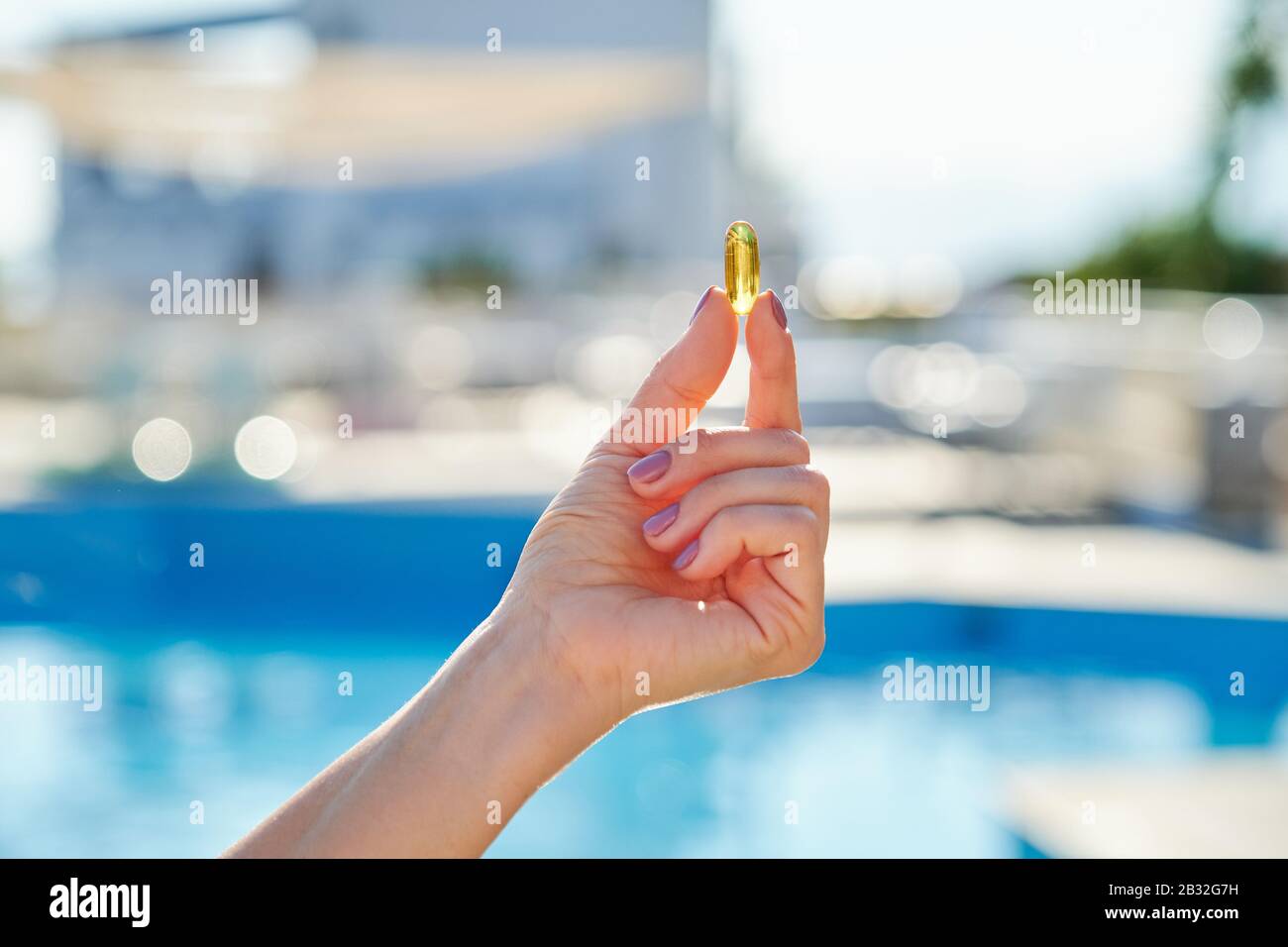 Sunny Golden Vitamin D Oil Capsule Omega 3 In Woman Hand Stock Photo Alamy