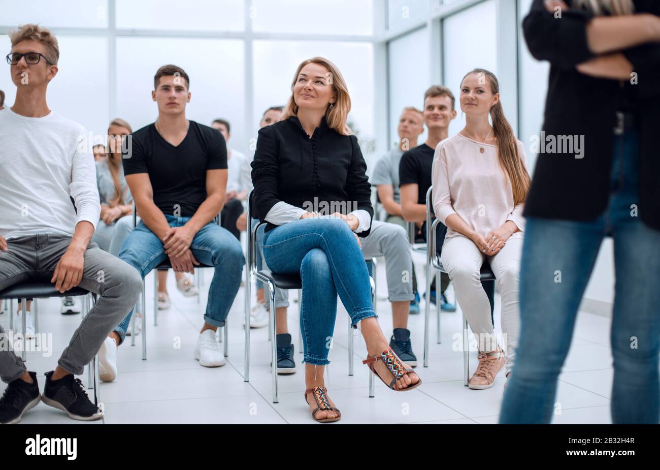 group of diverse young people sitting in a conference room Stock Photo ...