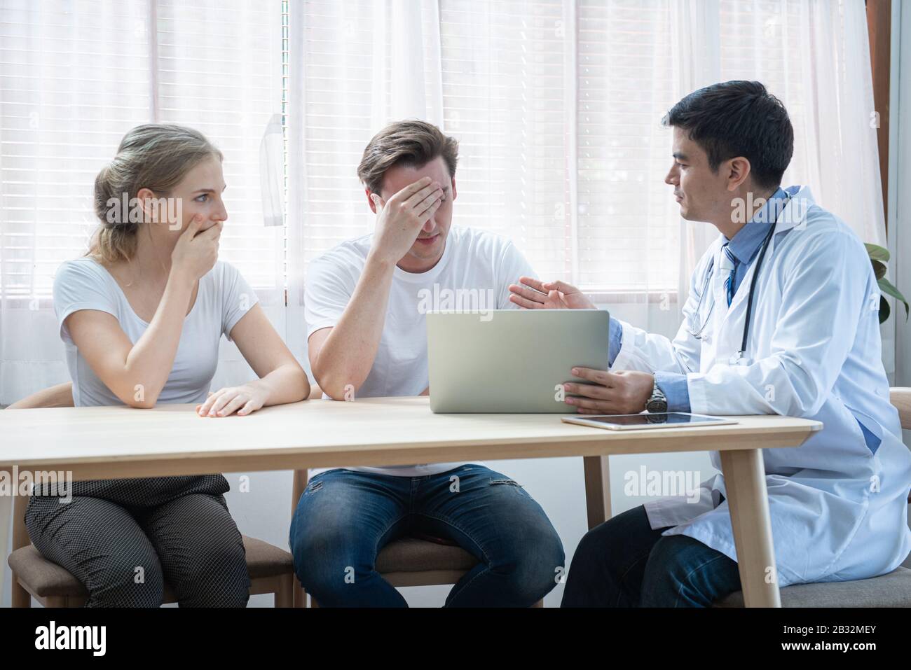 Unhappy caucasian young couple worried result of health illness ...