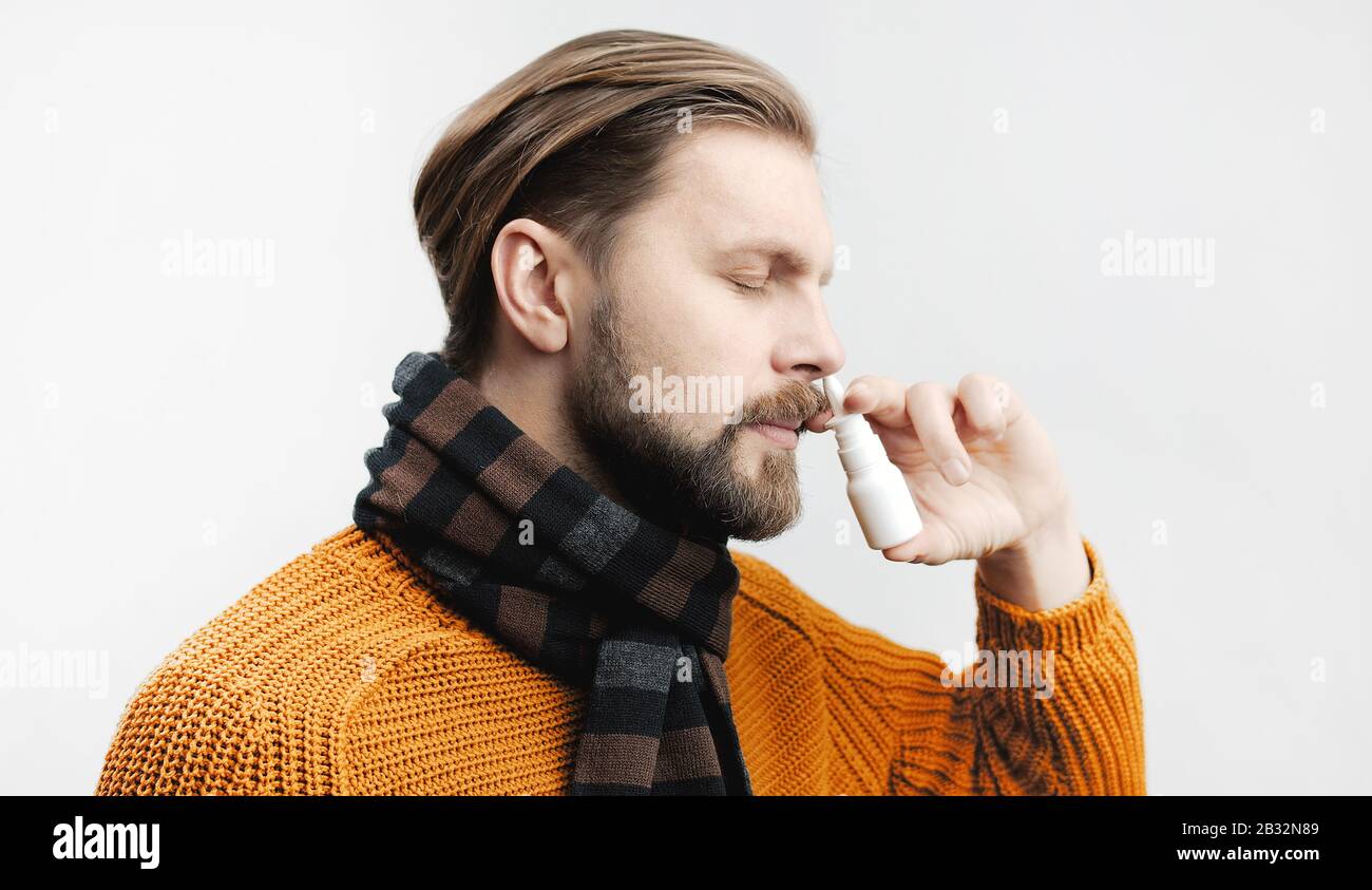 Man using nasal spray Stock Photo