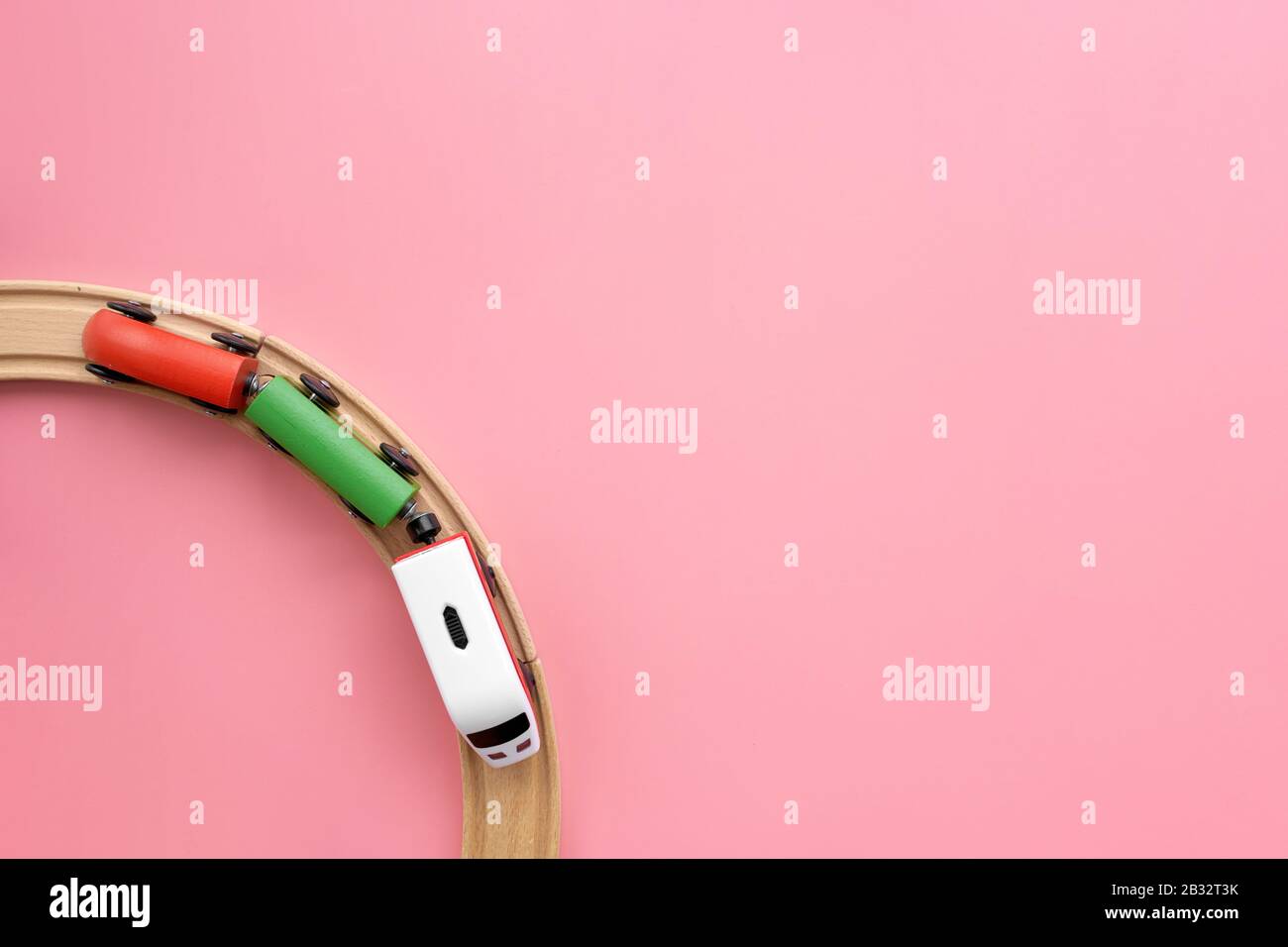Top view of circle wooden railway and train on pink background Stock
