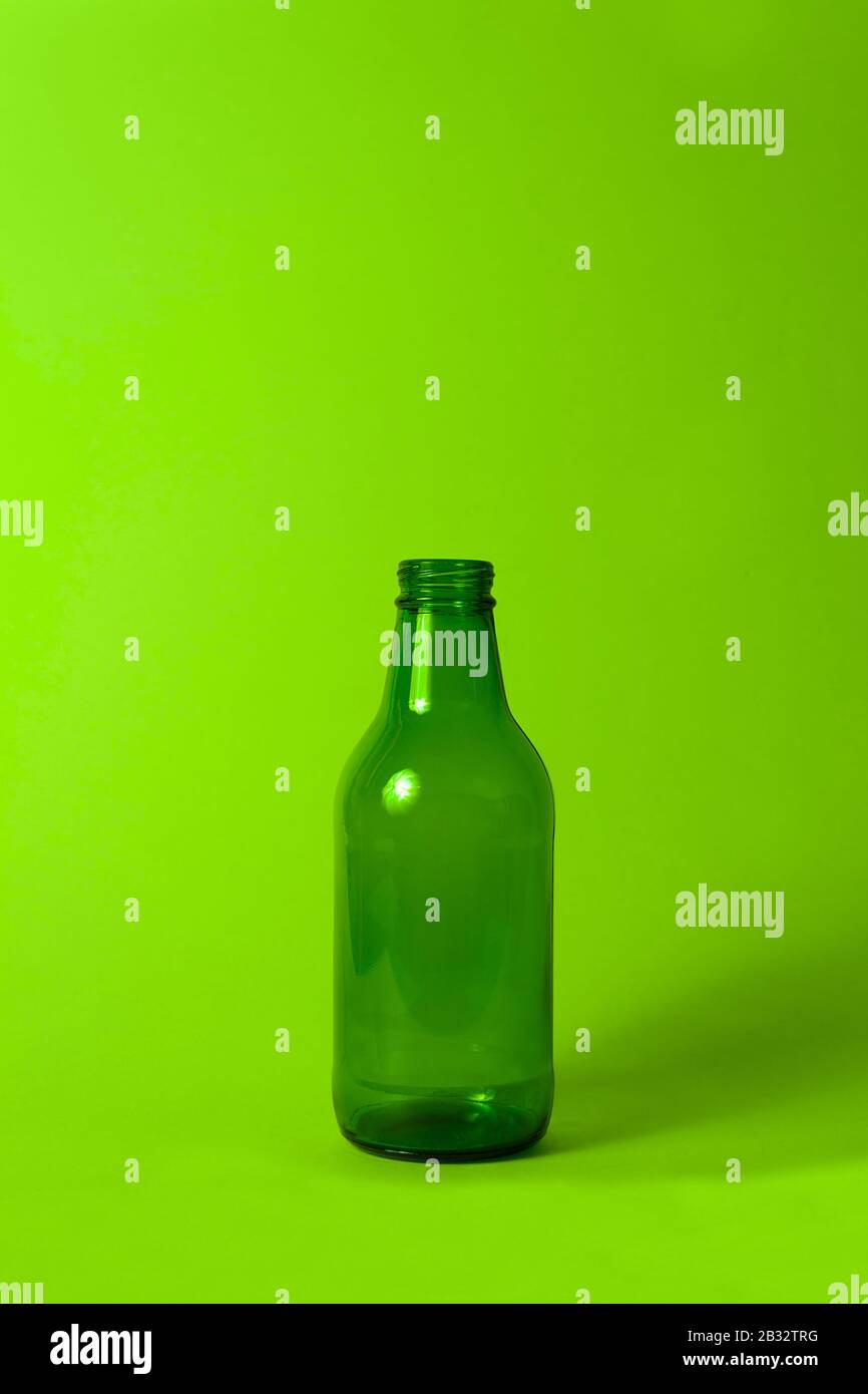 Download Small Empty Green Glass Bottle Without Cover And Label On Bright Neon Green Background Can Be Used As Mock Up For Juice Or Beer Stock Photo Alamy