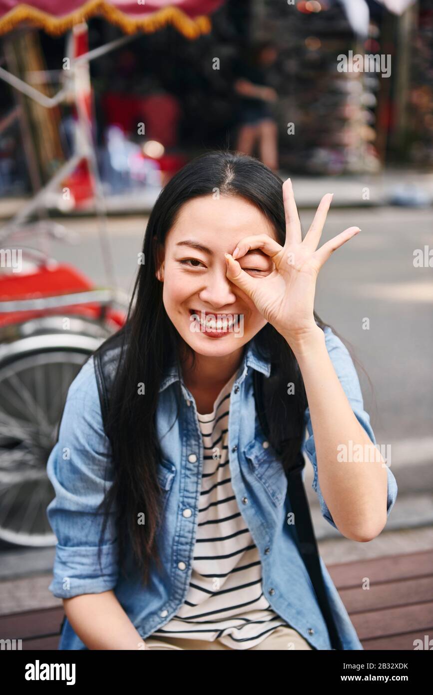 Portrait of happy woman showing ok sign Stock Photo