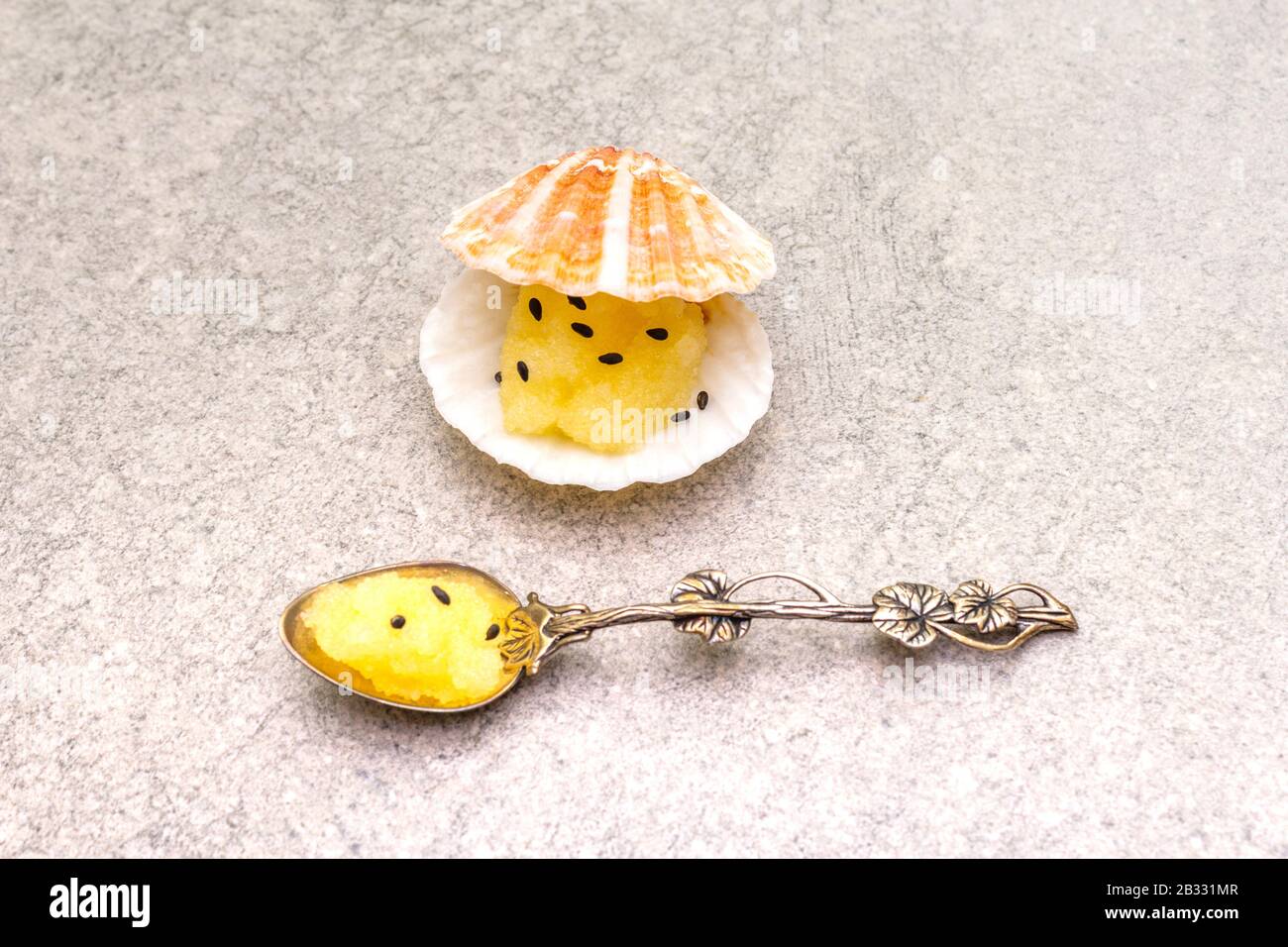Capelin roe in seashells, black sesame seeds. Lightly salted caviar ...
