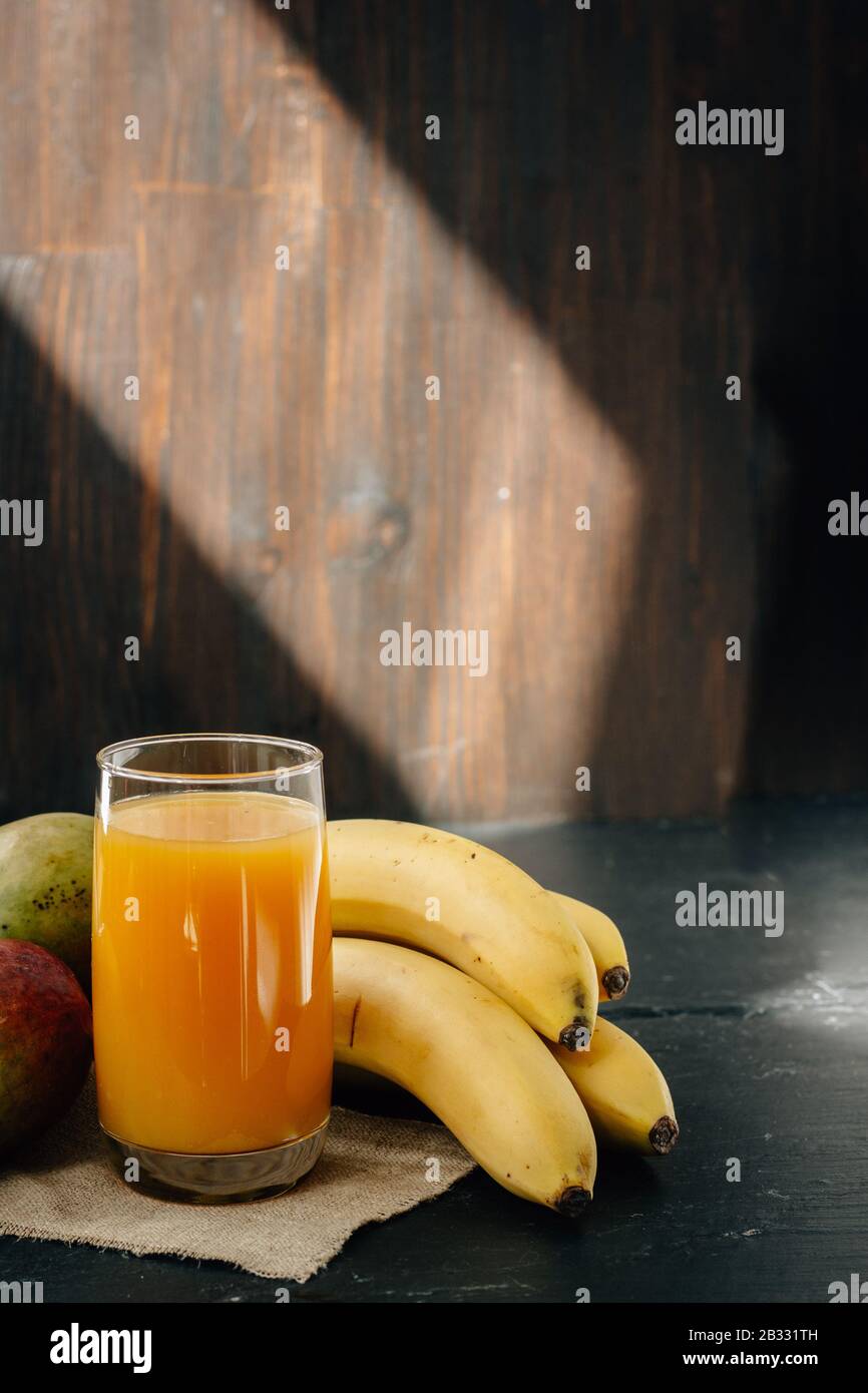 Mango and banana juice on black surface Stock Photo Alamy