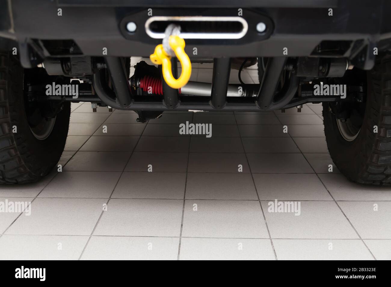 View of the bottom of the car with enhanced suspension and steering damper for offroad driving