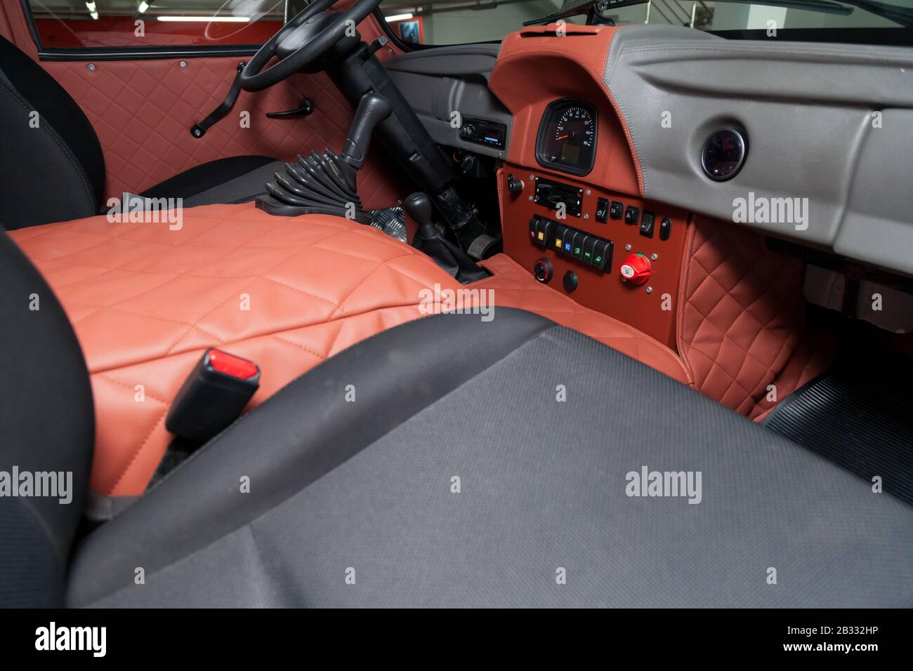 Novosibirsk, Russia - 02.26.2020: Red interior of used UAZ VAN 452 469 car with dashboard, steering wheel, and front seats prepared for off road drive Stock Photo