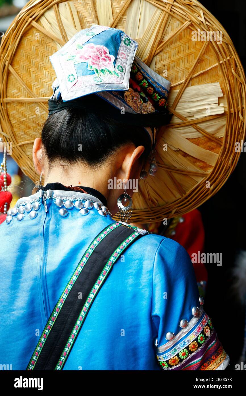 View from the back of chinese woman with traditional ethnic minorities costume and hat Stock Photo