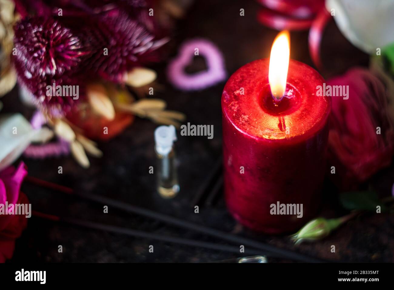 Flaming candle and perfume in glass bottles Stock Photo Alamy