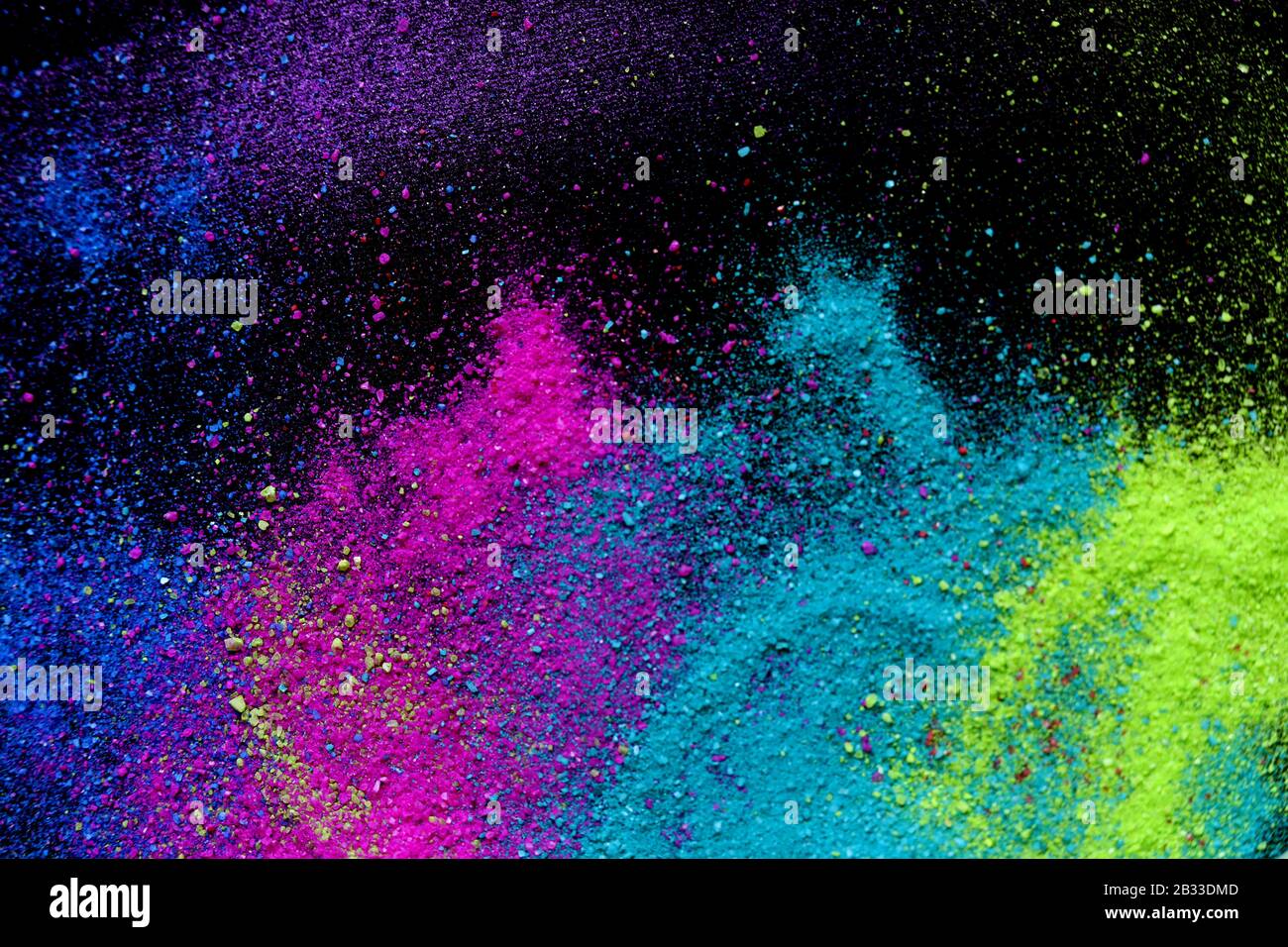 Multi-colored powder sprayed on black background. Holi celebration Stock Photo