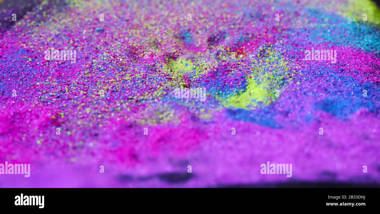 Multi-colored powder sprayed on black background. Stock Photo