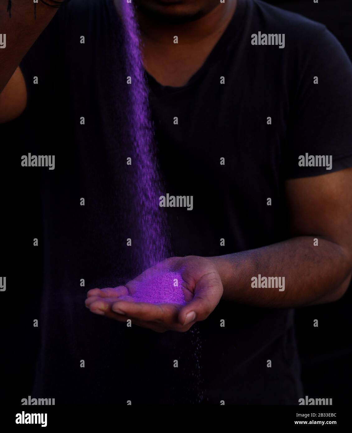 Holly Powder Exploding Holi festival concept. color powder exploding from the palm of a cupped ...