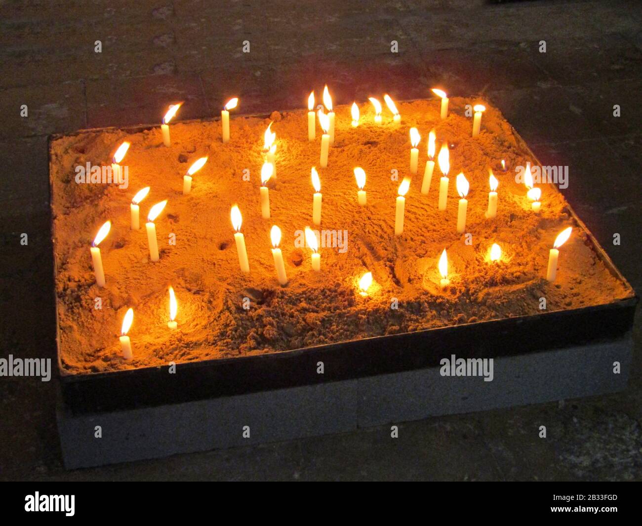 A Display of Lit Candles in a Sand Filled Tray Stock Photo Alamy