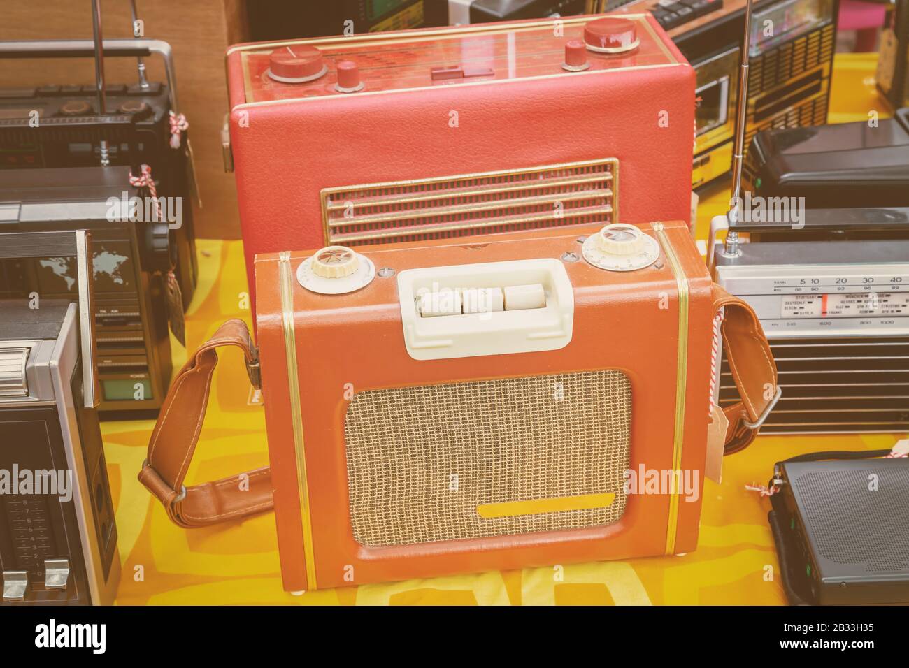 Retro styled image of old table radio's for sale on a flee market Stock Photo