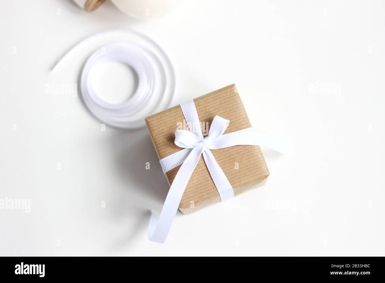 Holiday Gift. Christmas and New Year Still Life Composition in White and Beige Colors. Stock Photo
