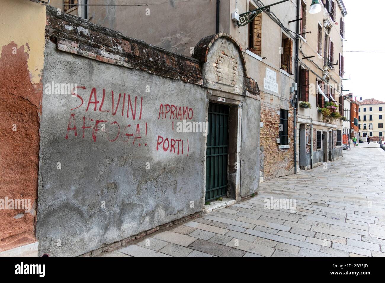 'Salvini drowns. Let's open the ports'  Graffiti on the streets of Venice, Italy could refer to Matteo Salvini migration policies Stock Photo