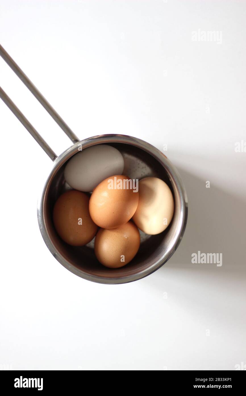 Overhead View of Eggs in a Pan. Colorful Hen's Eggs. Stock Photo