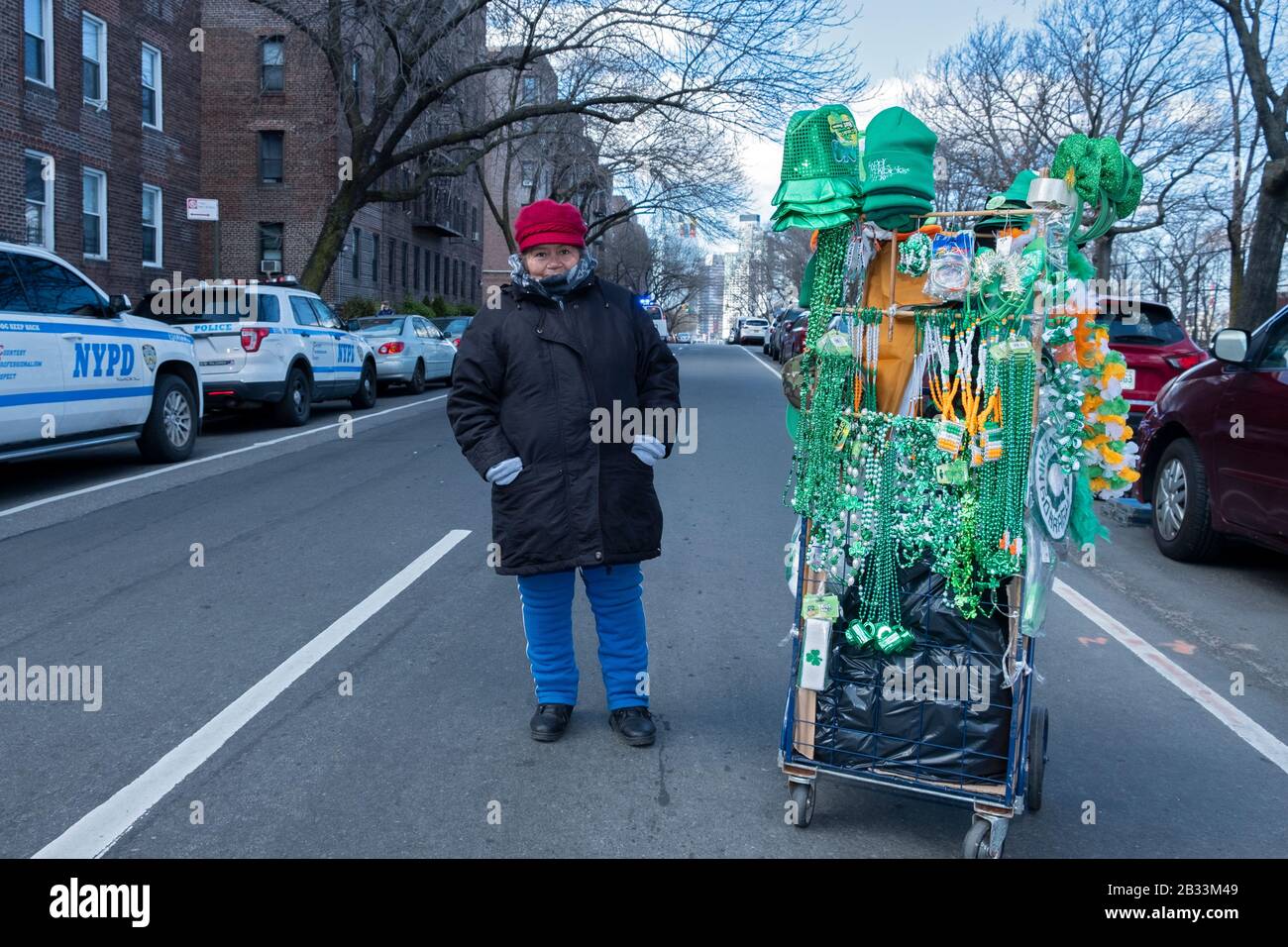 A woman from Ecuador selling green hats and beads for marchers to wear in the St. Patricks Day for All parade in Sunnyside, Queens, New York City. Stock Photo