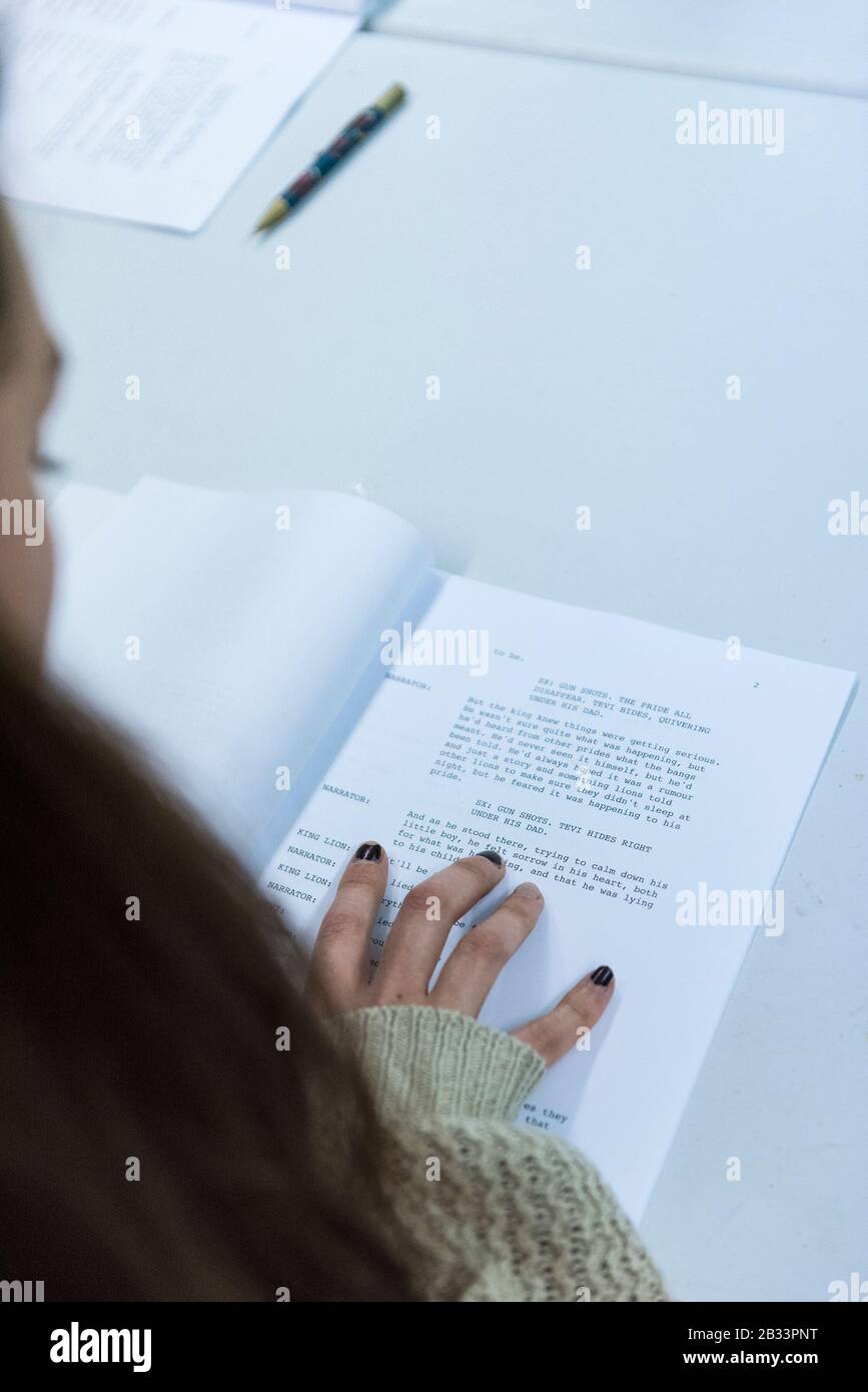 An actor concentrating on reading a new script in a first rehearsal in ...