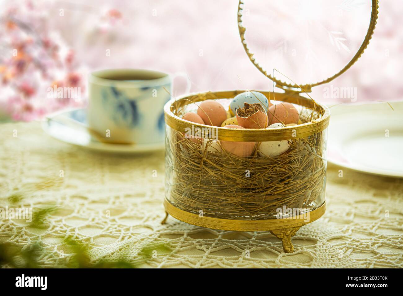 https://c8.alamy.com/comp/2B33T0K/beautiful-served-small-table-with-easter-decorations-on-outdoor-terrace-little-chocolate-bunny-with-bow-chocolate-eggs-cup-of-coffee-crystal-bowl-2B33T0K.jpg