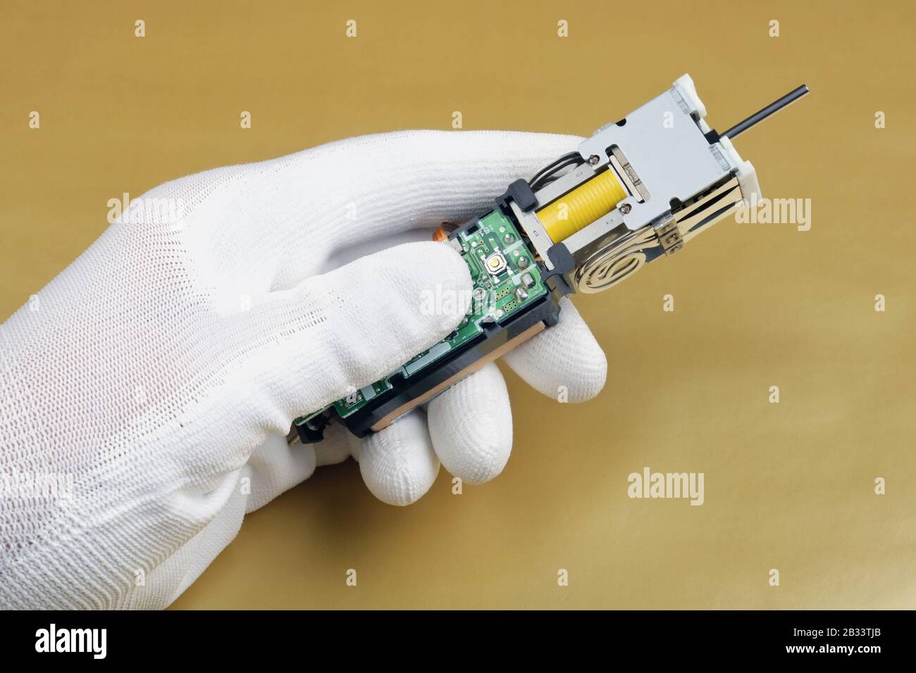 An electronics engineer hold in hand and checks and adjusts a medical ...