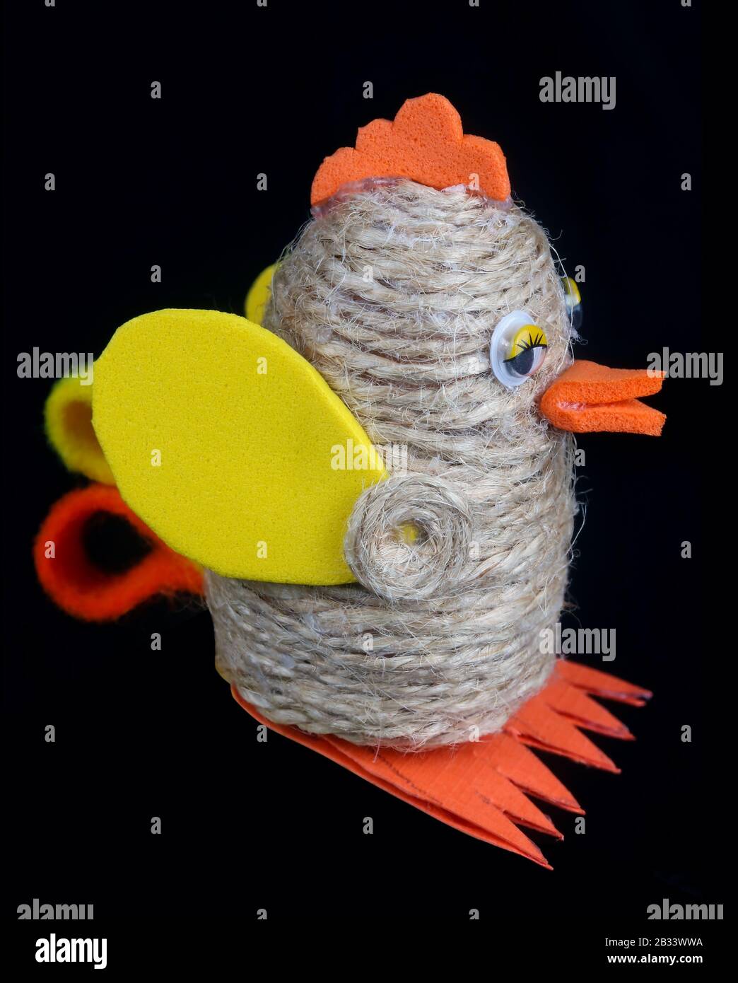 Funny handmade Easter  bird are made of linen rope and foam paper. Isolated on black  studio macro shot Stock Photo