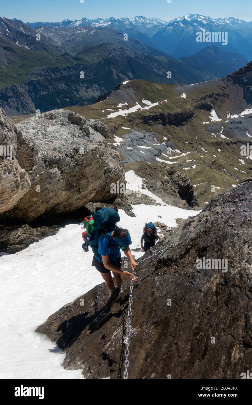 Trekkers using the cable chain at Faja de las Olas mountain pass.Ordesa National Park.Pyrenees.Huesca.Spain Stock Photo