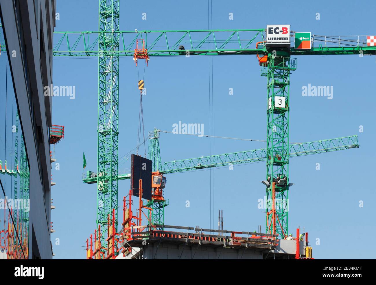 Construction cranes and shell construction of a commercial building in Hamburg's HafenCity, Hamburg, Germany, Europe Stock Photo