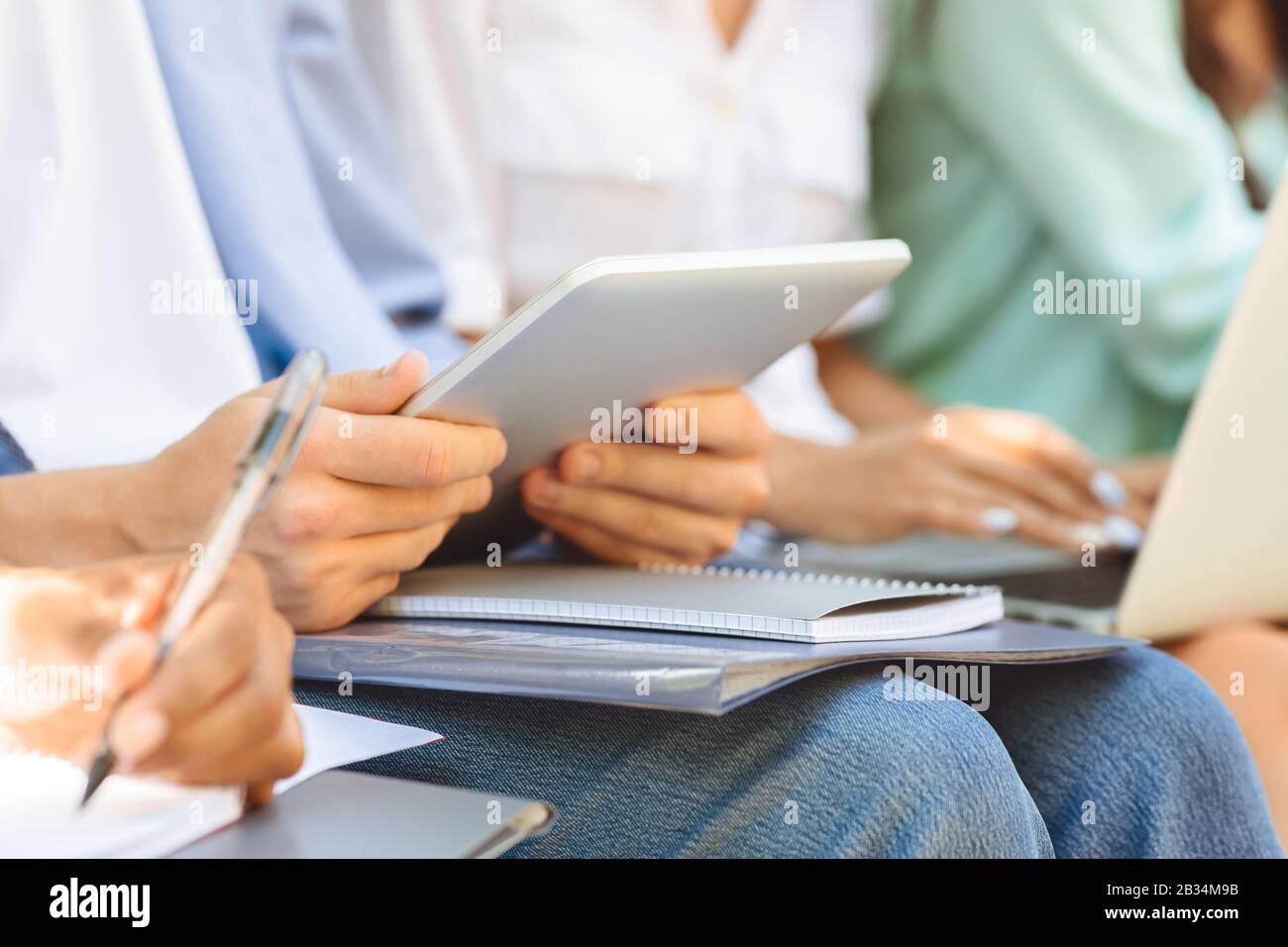 Unrecognizable Male Student Using Digital Tablet Outdoors, Preparring For Classes, Closeup Stock Photo