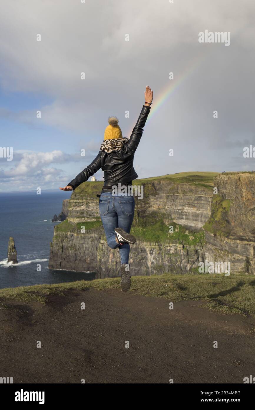 woman jumps near the cliff of moher Stock Photo - Alamy