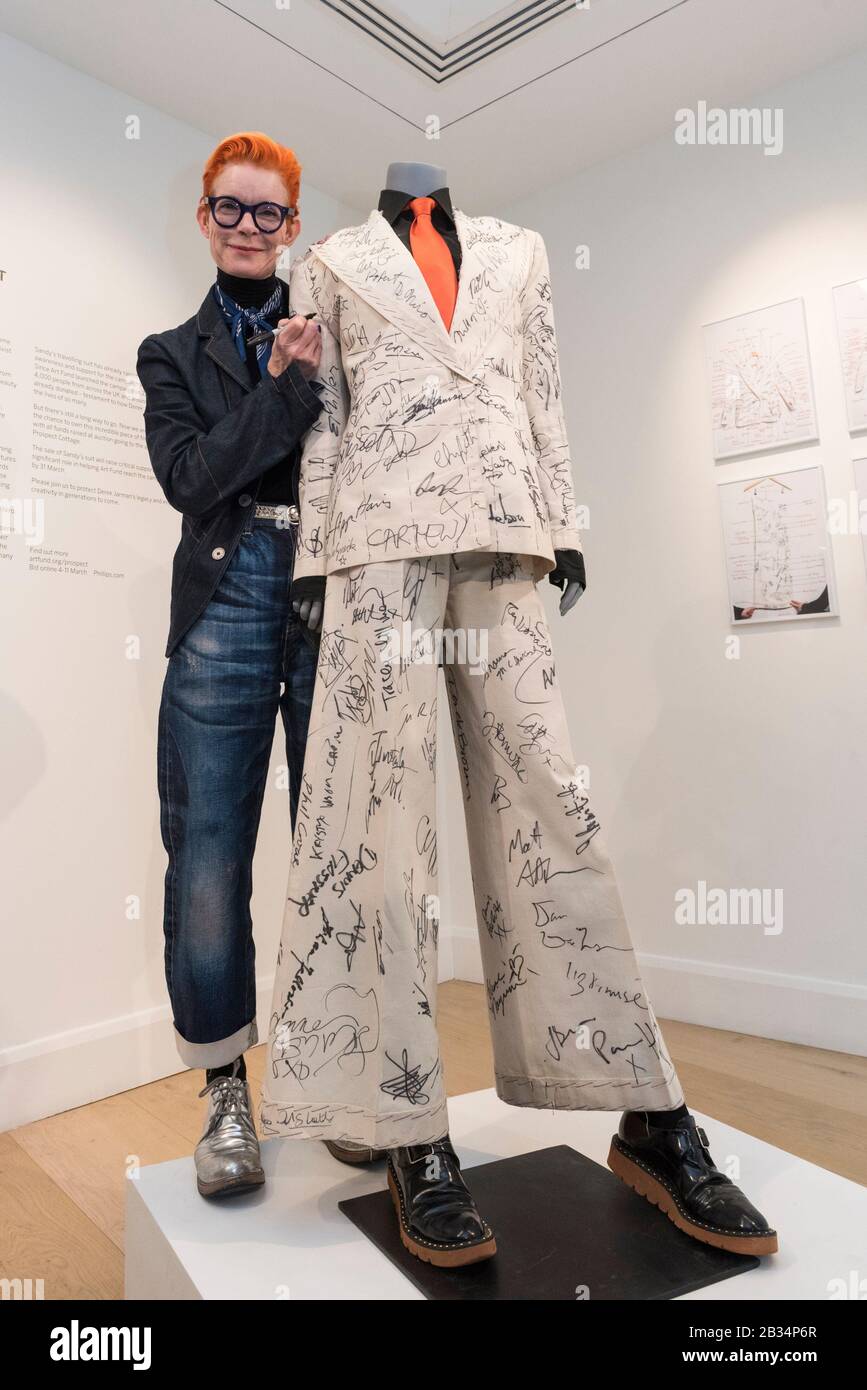 London, UK.  4 March 2020. Academy-Award winning costume designer Sandy Powell signing her suit, on display ahead of being offered for auction at Phillips, Berkeley Square.  Worn by Powell at the 2020 BAFTAs and Oscars, the cream calico toile suit includes autographs from over 100 movie stars.   Proceeds will go towards Art Fund's public appeal to save and protect Prospect Cottage in Dungeness, Kent, home of filmmaker Derek Jarman.  The online auction runs 4 to 11 March 2020. Credit: Stephen Chung/Alamy Live News Stock Photo