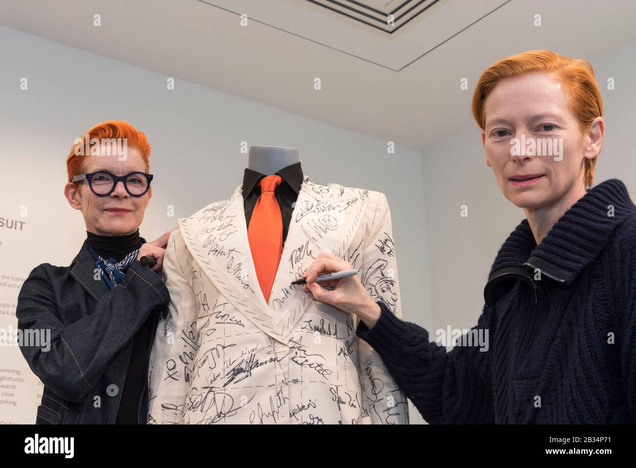 London Uk 4 March Tilda Swinton R And Academy Award Winning Costume Designer Sandy Powell Signs The Suit On Display Ahead Of Being Offered For Auction At Phillips Berkeley Square Worn By