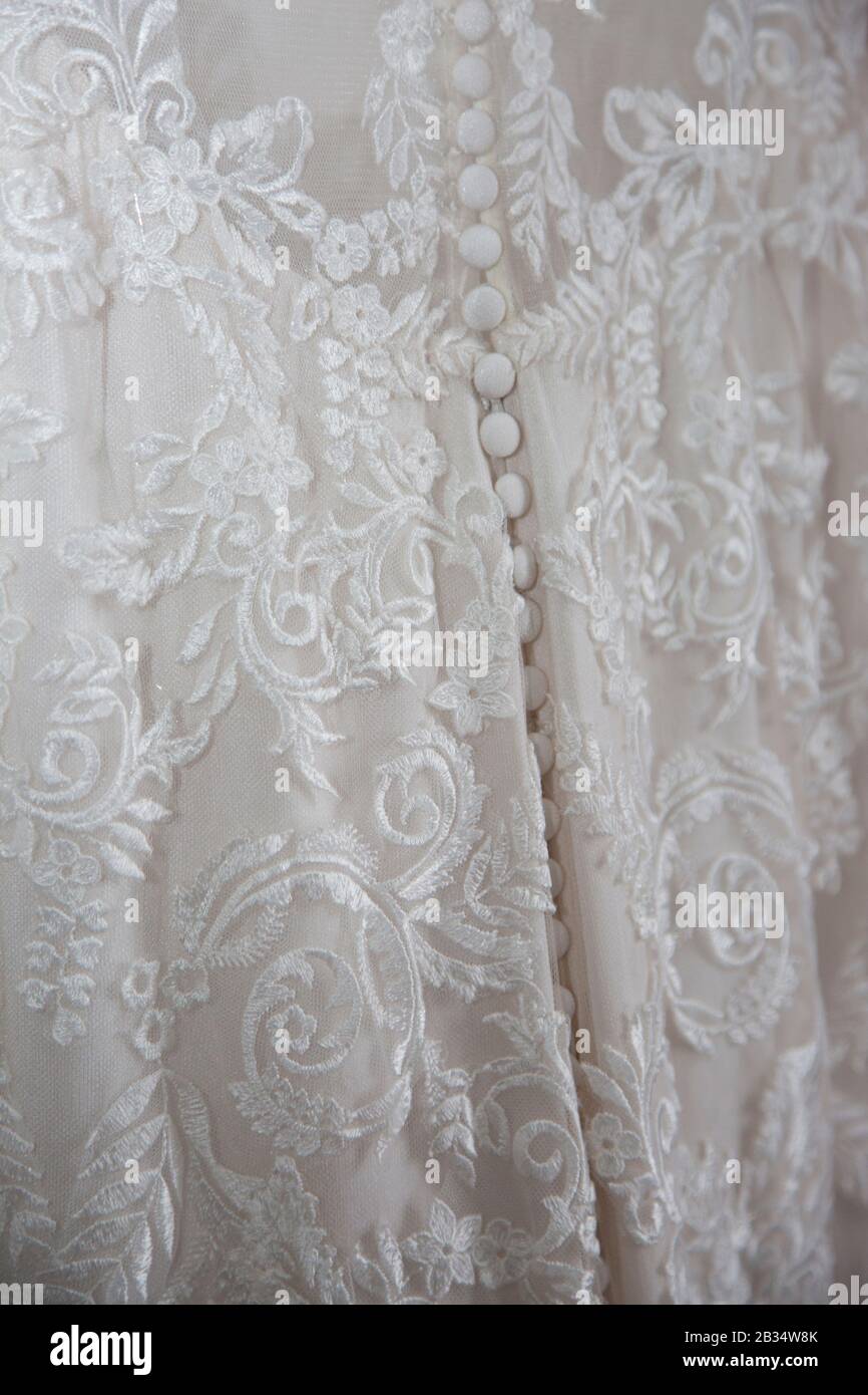 Close up of wedding dress on the brides wedding day, close up of white lacey wedding dress Stock Photo