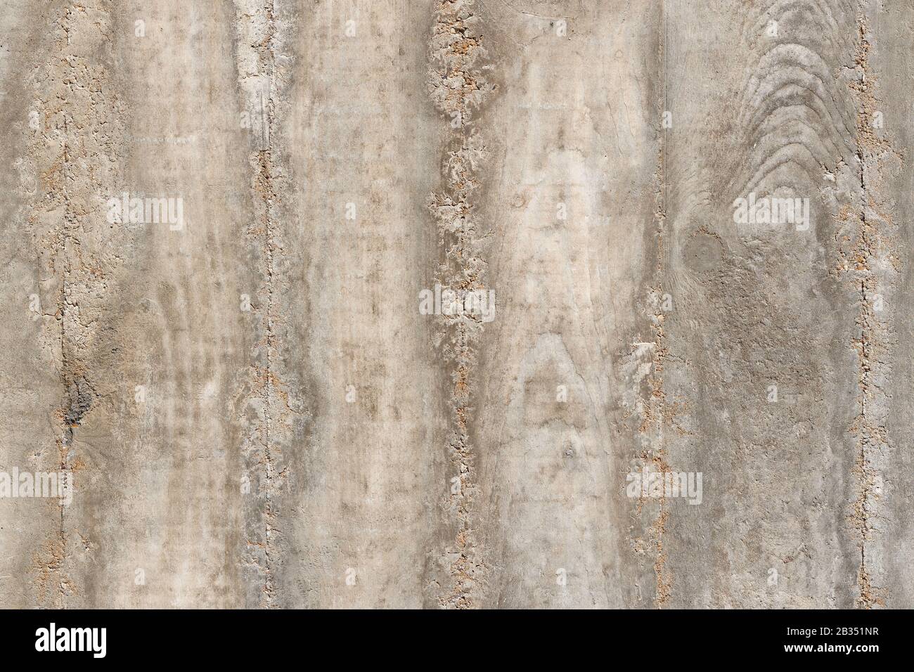 Concrete  Background Texture - grey-brown: background detailed texture of a rough grey-brown concrete wall, showing imprints of  wood lining's wooden Stock Photo