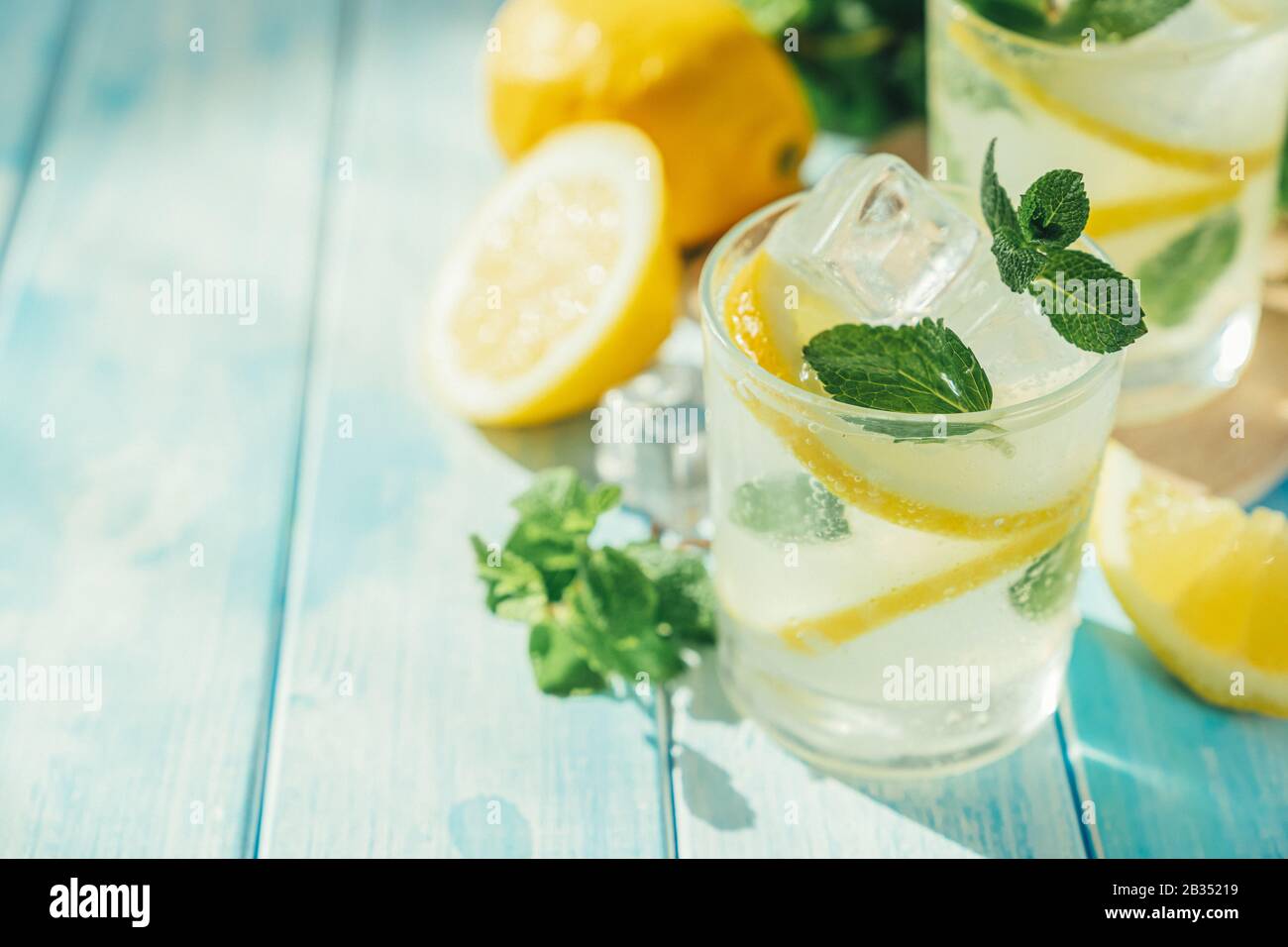 Lemonade and ingredients on blue wood background Stock Photo