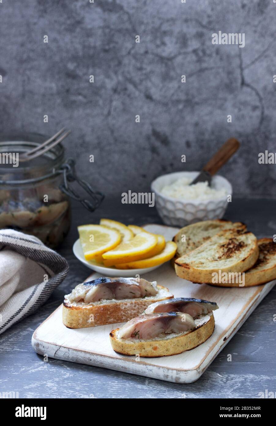 Sandwiches with cottage cheese and gravlax from mackerel, served with