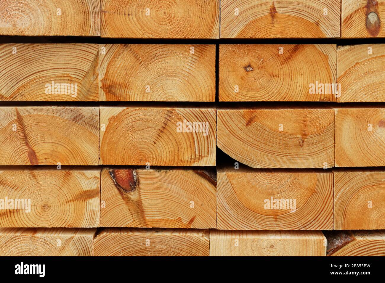 Construction Timber Background: Cutting Edges of Piled Pine Thick Boards Stock Photo