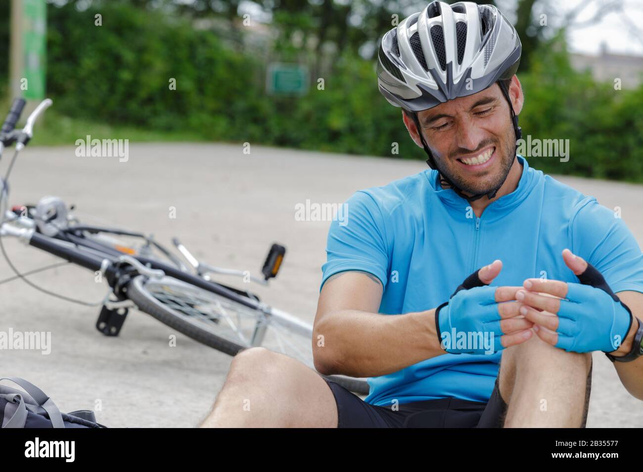 adult man with sore knee after falling from bicycle Stock Photo Alamy
