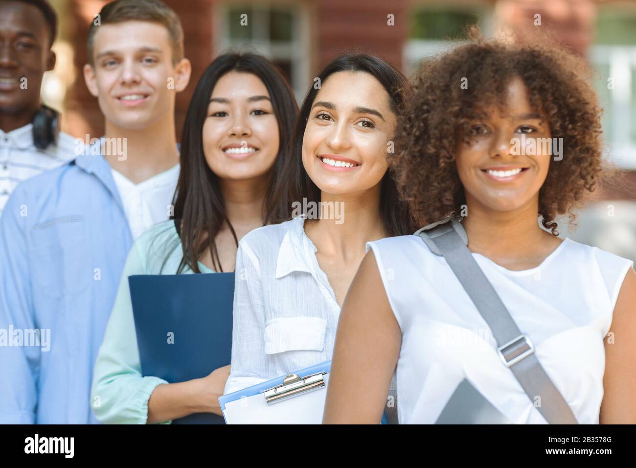 Closeup Portrait Of Multi-Ethnical Teens Posing Outdoors Stock Photo