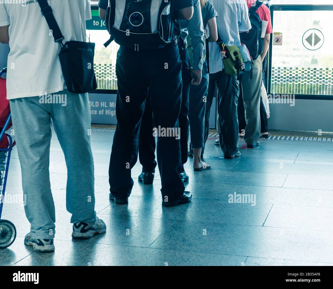 Diverse people waiting in line at MRT Mass Rapid Transit train station