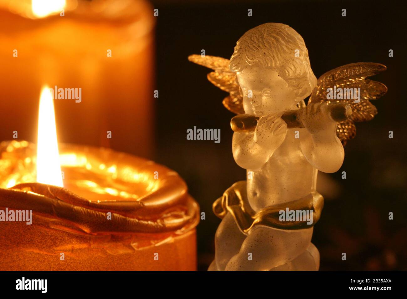 Advent Angel: transparent decoration angel making music upon Advent wreath Stock Photo