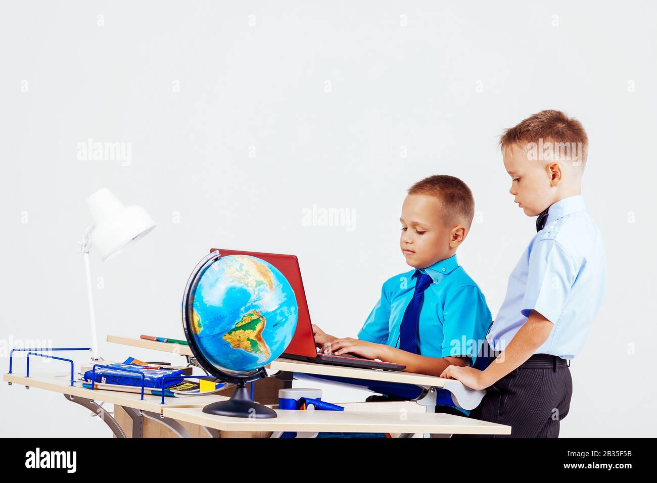 Two Boys School Computer Desk Globe Education Stock Photo