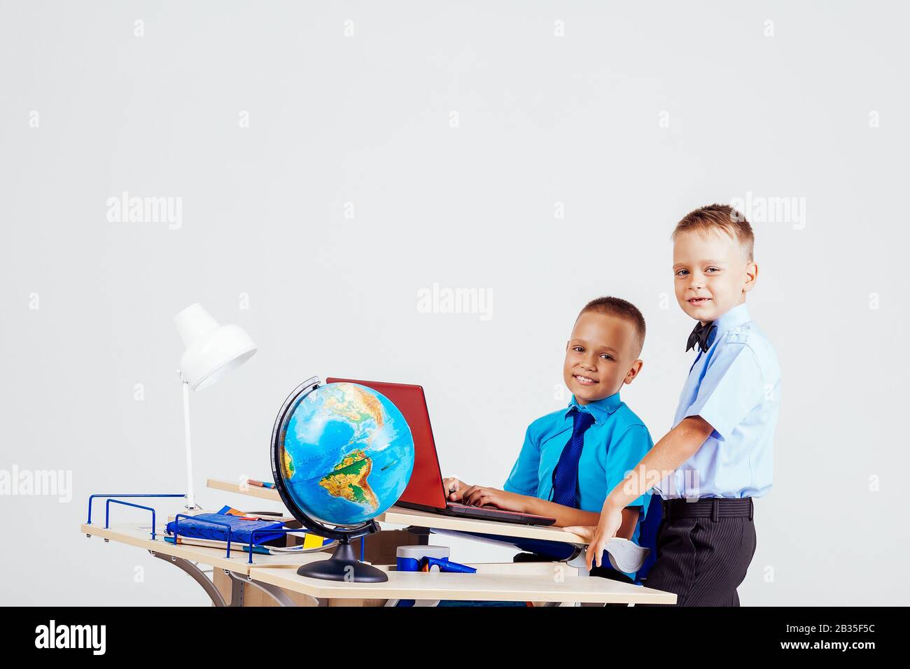 Two Boys School Computer Desk Globe Education Stock Photo