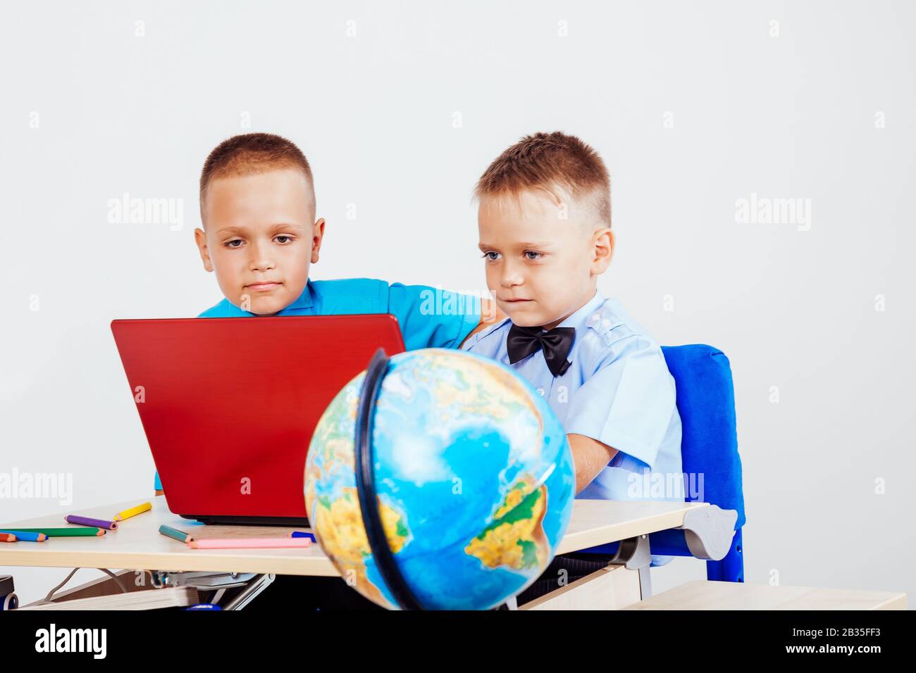 two boys sitting at the computer school Stock Photo - Alamy