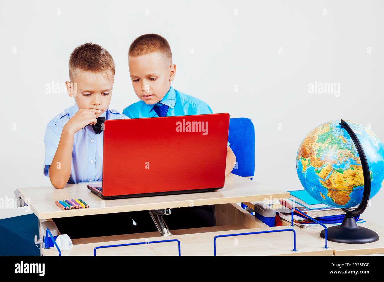 two boys sitting at the computer school Stock Photo - Alamy